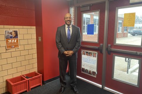 man standing in a school hallway