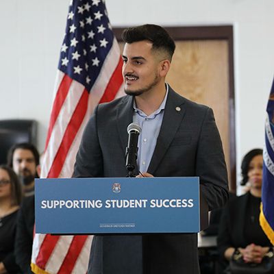 Michigan Sen. Darrin Camilleri speaking into a microphone 