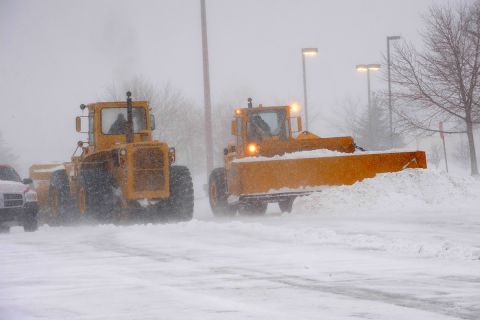 Snow plow busy clearing streets and roads during Winter season