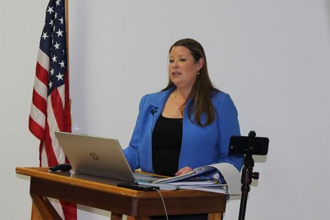 Stefanie Lambert speaking at a podium