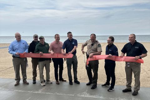 People standing in line in front of the beach 