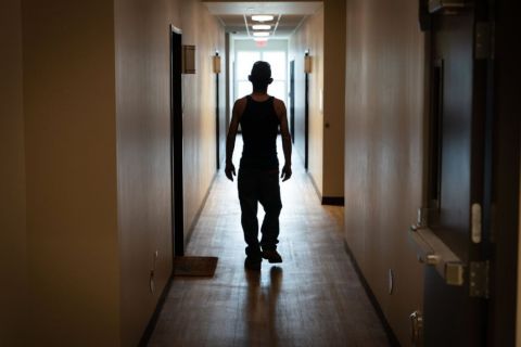 A man walking down a hallway at the Andy’s Place recovery housing in Jackson