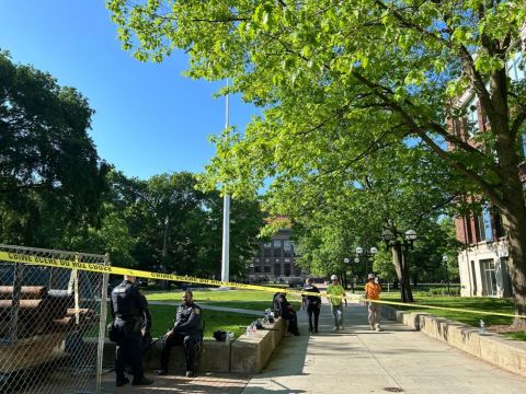  Police sit on the University of Michigan Diag, which was surrounded by caution tape