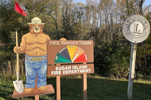 Smokey the Bear show a very high fire risk. The sign is outside the Sugar Island Fire Department