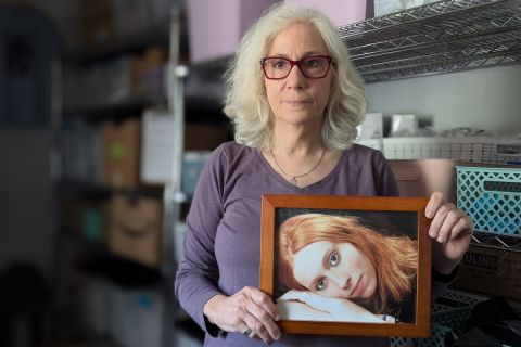 Woman holds a photo of her daughter