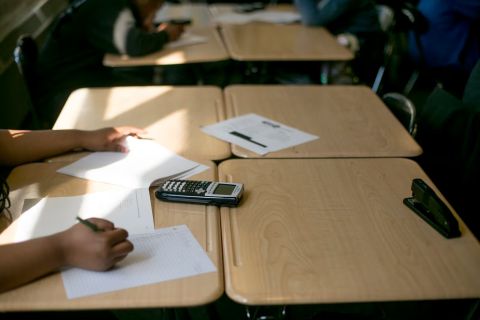 A student working on a math problem in a classroom