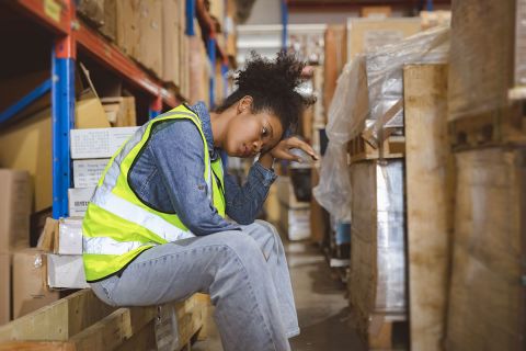 Tired stress woman worker labor working in warehouse