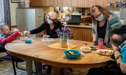 Holly VanVolkinburg, a supervisor, assists Larry Cook, 61, with lunch while Kathy Collier, Assistant Supervisor at MOKA, assists Stanley DeGlopper, 58, earlier this month at the Academy Home in Allegan.