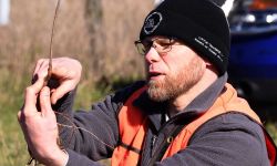 Noah Jansen, conservationist for the Little Traverse Bay Bands of Odawa Indians, explains planting depth to volunteers on Friday, April 30, at Ziibimijwang Farm near Carp Lake.