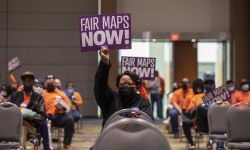 Residents hold up signs protesting 