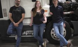 three people in front of the truck