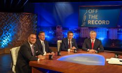 candidates around a table at a TV studio