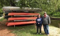 two people by kayaks