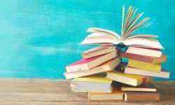 books in front of a chalkboard