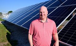 man in front solar panel