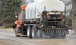 truck spraying brine on the road