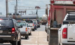 Cars wait as train crosses road