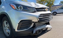 busted fender on a grey suv