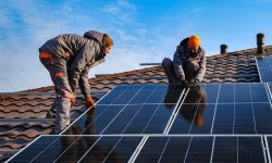 Workers installing solar cell farm power plant eco technology.