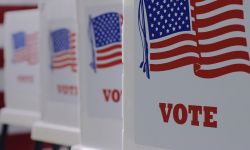 Straight on row of voting booths at polling station during an election. 