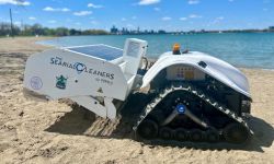 a small white robot on the beach