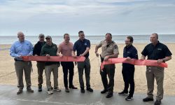 People standing in line in front of the beach 