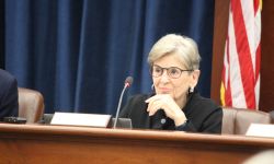 Woman sits behind desk