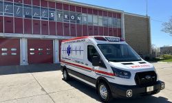 An ambulance parked in front a fire station 