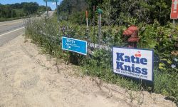 Two signs by the side of the road