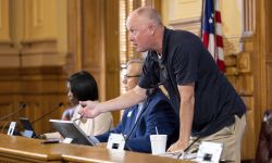 State Election Board member Rick Jeffares stands up from the podium