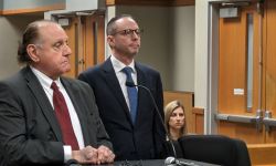 Rob Minard (center) and Anne Minard (back right) in court next to their attonery