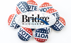 Bridge Michigan logo, with vote buttons behind it 