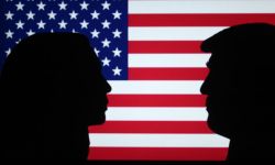 A silhouette of Kamala Harris and Donald Trump on an American flag