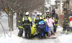 Residents next to rescue crews in Detroit. 