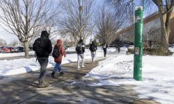 Students walking on a college campus. 